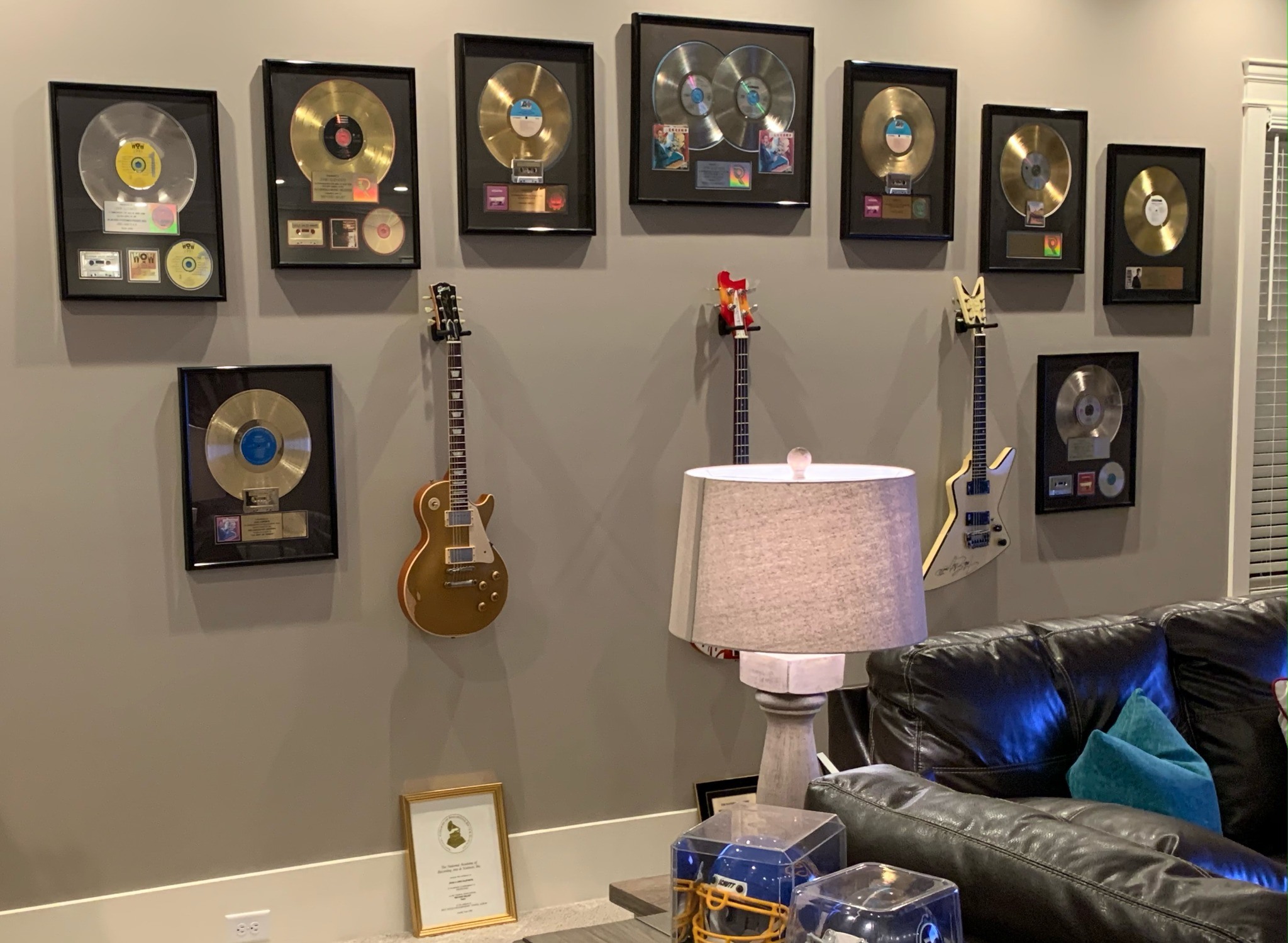 John Elefante gold and platinum record awards displayed with guitars